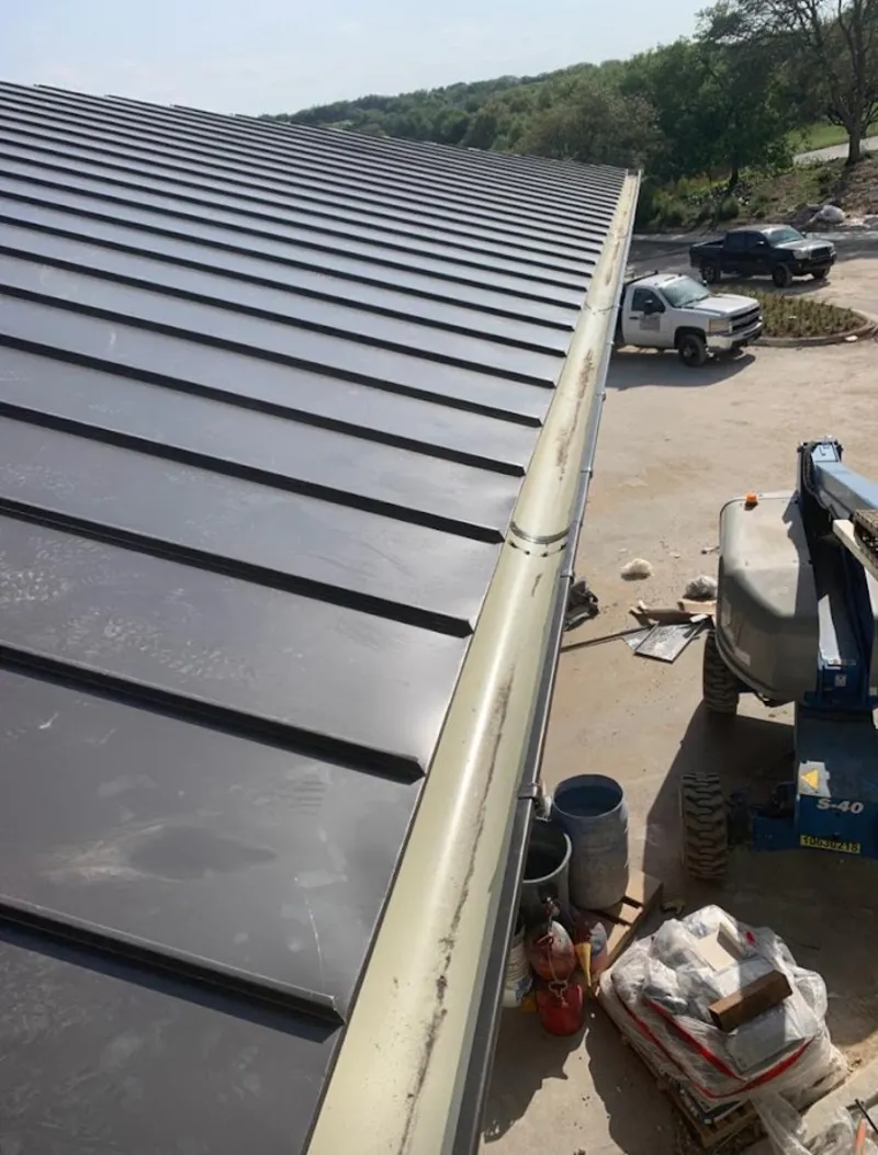 Standing seam panel and gutter detail on a metal roofing jobsite in Chesterfield